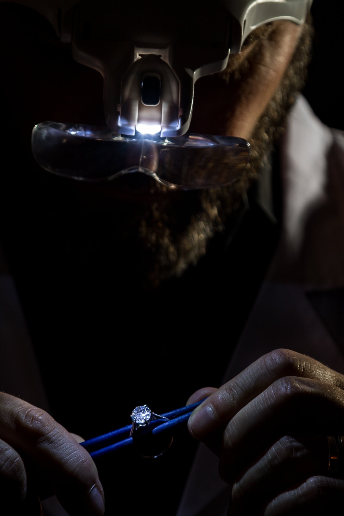 A diamond examined closely under a jeweller's loupe
